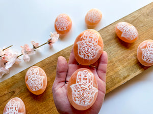 Peach Selenite Engraved Hamsa Palm Stone